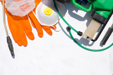 Equipment for safe spraying pesticides on the white surface, top view