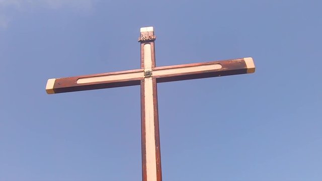 Christian cross on a bright day with the blue sky in the backround.