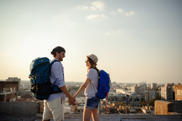 Obraz na płótnie Canvas Multiethnic traveler couple using map together on sunny day
