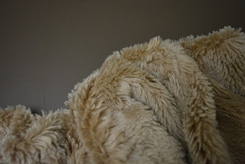 Soft coffee synthetic fabric in the form of natural long fur. Brown synthetic fur in spacing...