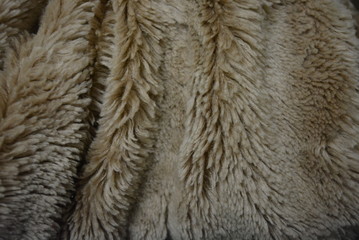 Soft coffee synthetic fabric in the form of natural long fur. Brown synthetic fur in spacing...