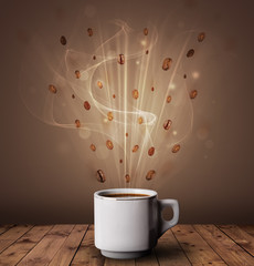 Steaming cup of coffee and coffee beans
