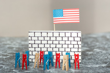 imitation of people against a wall border, bricks on white with an American flag