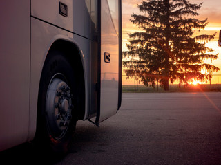 Bus, camper van travels at sunset