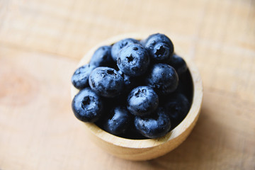 blueberries fruit in bowl on the wooden table