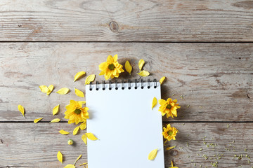 Vintage yellow chrysanthemums placed on the table old wooden with book diary for text