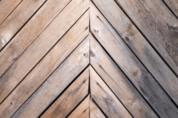 Background, old gray wooden boards stacked herringbone