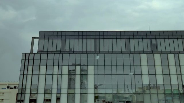 timelapse of clouds with high rise skyscrapes corporate buidling