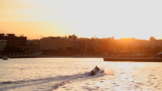 A man in a boat goes to sunset thinking of home and infinity