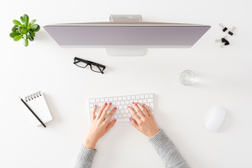 Woman using computer. Office desktop with accessories