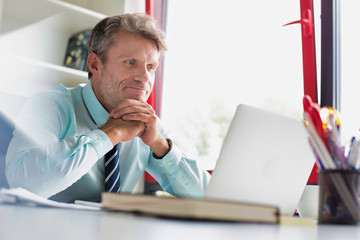 Fototapeta premium Senior business man taking an internet conferene call and looking glum