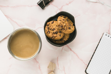 Office desktop with a coffee cup and cookies