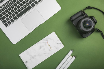 Office desktop with a laptop and a photo camera