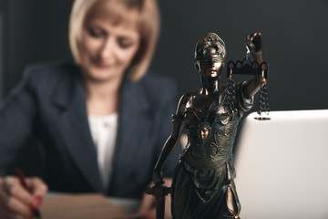 Closeup view of Themis on the desk. Female attorney concept