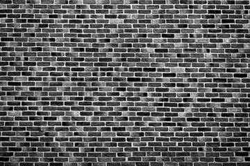 Naklejka na ściany i meble Vintage black brick wall background texture. Architecture grunge detail abstract theme. Home, office or loft design backdrop style.