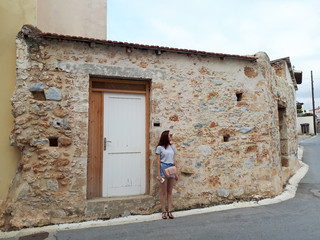 Fototapeta na wymiar Beautiful woman in cute streets of Agios Nikolaos, Crete, Greece. Traveling to Europe.