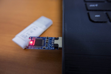 USB Drive without cover Light and plug in with notebook.Technology education storage breach concept.