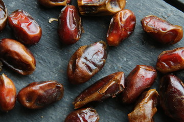 Many delicious dates lie on a beautiful, vintage table