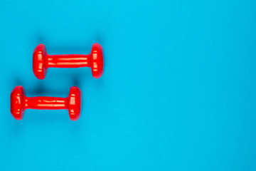 Two dumbbells on blue background