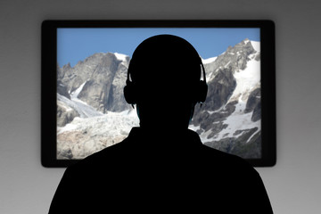 man silhouette with earphone wacht television with copy space for your text