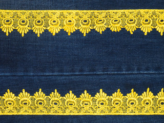 Yellow lace on a jeans background. Sewing still life