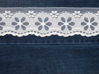 White lace on a jeans background. Sewing still life