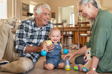 Cute little boy playing with grandparents
