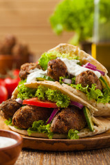 Kebab, kofta in pita, bun. Traditional southern European dish. Front view.