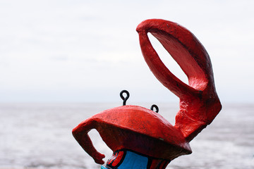 Crab statue on beach