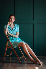 Girl with beautiful legs sitting on a chair