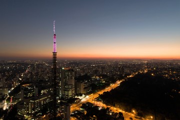 Fototapeta na wymiar Sunset aerial view in São Paulo, Brazil. Great landscape. Explosion of colors on skyline. Business travel. Travel destination.