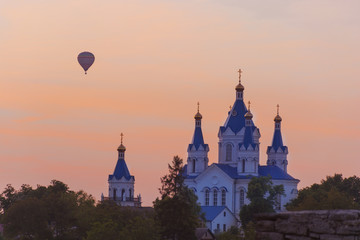 Landscape of beautiful balloons flying near сathedral on sunset. Ukraine, Kamyanets-Podilsky, Saint George's сathedral