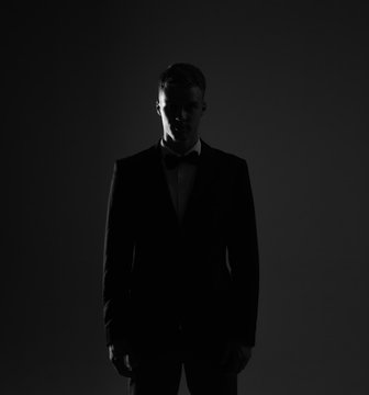 Silhouette black and white portrait no face of a man in a suit.