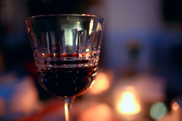 red wine glass serving / romantic dinner in the interior of the restaurant, a table served with a glass of grapes wine