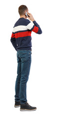 Fototapeta premium back view of business man talking on mobile phone.