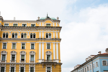 Fototapeta na wymiar yellow building with white windows in Rijeka, Croatia