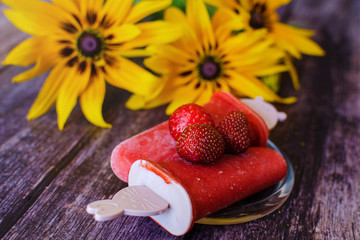 Strawberry popsicles, popsicles, popsicle, lying on a plate on a floral vintage wooden background....