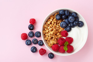 High protein and diet breakfast. Homemade granola crisp with raspberry, blueberry and greek yogurt. Top view.