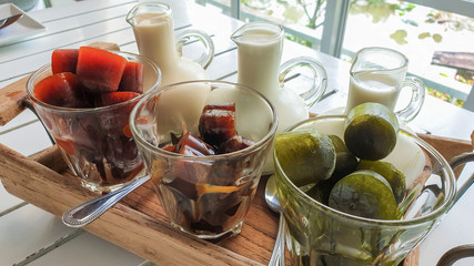 tea, coffee with ice on cup side has a milk jug in the wood. beverage cool of summer