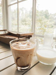  coffee with ice on the cup on the wooden table Cold drinks in the summer. Top view
