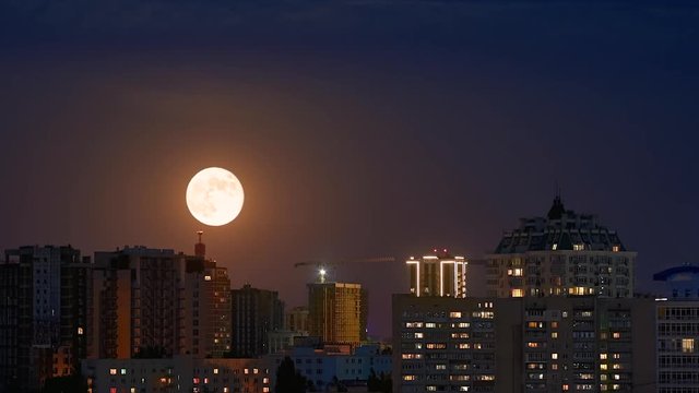Timelapse full moon rising ower cityscape in Kyiv 1080p 60fps