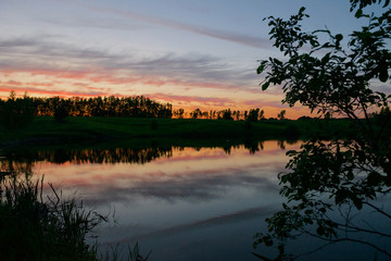 Fototapeta na wymiar Evening landscape with lake and setting sun