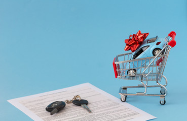 Concept of selling cars on blue background. Sell and buy car, car financing, car key for Vehicle...