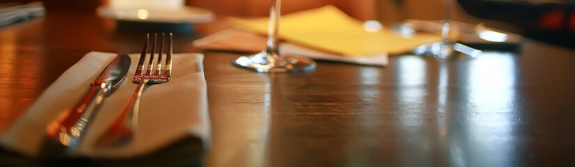 fork and knife serving in the interior of the restaurant / table in a cafe, food industry catering, menu