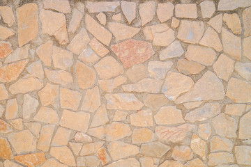Masonry wall of stones with irregular pattern texture background