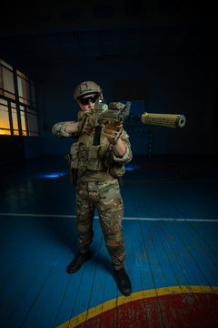 A Team Of Airsoft Players In The Old School Gym In Combat Positions