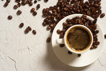 Coffee background, top view with copy space. White cup of coffee, ground coffee, coffee beans on white background