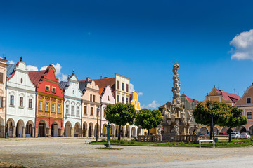 Fototapeta premium Main square of Telc city, a UNESCO World Heritage Site, on a sunny day with blue sky and clouds, South Moravia, Czech Republic.
