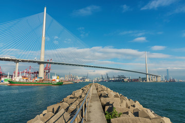 Fototapeta premium Cargo port, suspension bridge and dam in Harbor
