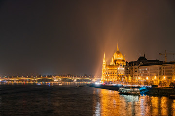 Fototapeta na wymiar Night view of the Hungarian Parliament Building and River Danube bank